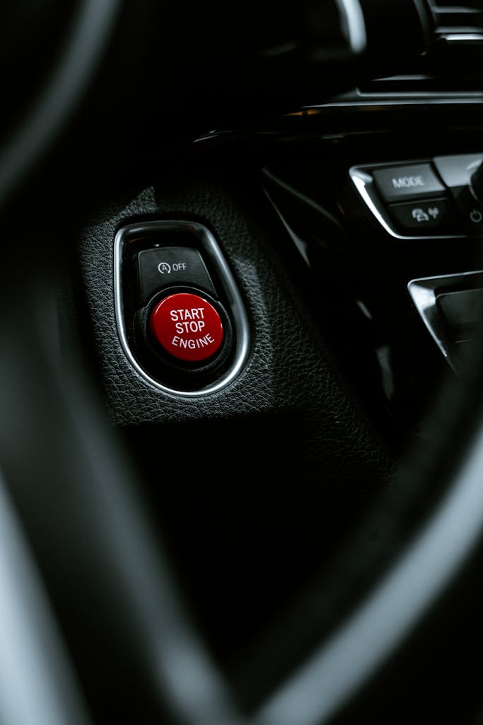 Detailed view of a start stop engine button in a car interior, highlighting modern automotive design.